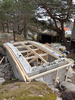 Timber beams across the root cellar supporting the roof form.