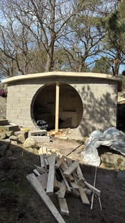 Cast concrete roof on a root cellar with a large circular entrance.